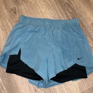 Nike athletic shorts, blue with attached black spandex underneath, size Medium